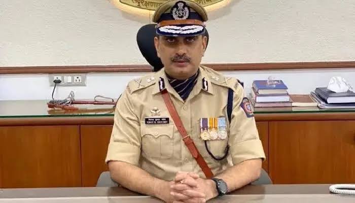 Vinoy Kumar Choubey in ceremonial uniform with peaked cap and service medals at the commissioner's office.