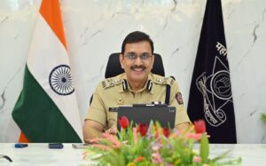 Vinoy Kumar Choubey seated at his office desk in service uniform.